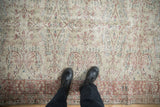 Overhead view of the distressed pile and muted floral pattern on a vintage Sparta carpet.