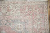 Distressed vintage Sparta rug showing worn pink, ivory Samovar Turtle border and machine bound edge.