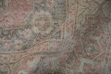 Distressed pink, ivory, oxidized silver floral pattern, highlighting worn texture.