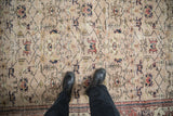 Distressed vintage Sparta carpet with beige ground, allover lattice vine, dusty cherry red floral motifs.