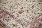 Dusty cherry red main border with Samovar Turtle motifs on the distressed beige Sparta rug corner.