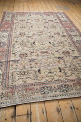 Distressed beige Sparta rug pile with navy and dusty cherry red Samovar Turtle border motif.