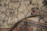 Detail of vintage distressed Sparta carpet showing worn beige pile with lattice vines and dusty red border.