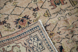 Distressed beige vintage Sparta carpet: mostly even pile wear, exposed foundation, geometric border reverse.