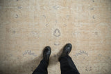 Decorative wear and low-pile texture on a vintage Sparta carpet in cream and dusty blue.