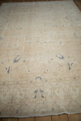 Low-angle view of the distressed vintage Sparta carpet, showing the worn texture and visible knot heads.