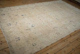 Full perspective view of a vintage distressed Sparta carpet showing its allover floral pattern.