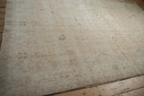 Angled perspective on the distressed Sparta carpet's low-pile texture and time-softened floral pattern.