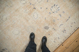 Distressed vintage Sparta carpet showing worn texture, dusty sandalwood, and faded navy blue patterns.