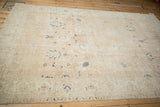 Distressed Sparta carpet pile with visible foundation, showing faded dusty sandalwood and navy design.