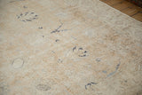 Distressed Sparta rug showing exposed foundation, faded floral lattice, and dusty tones.