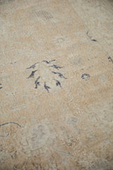 Close-up of distressed Sparta carpet's worn texture, ivory foundation, and dusty navy pattern.