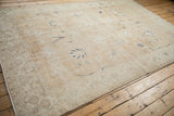 Detail of vintage distressed Sparta rug's worn pile, exposed foundation, and machine-bound edge.