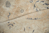 Distressed Sparta carpet pile, showcasing worn texture and faded dusty navy floral elements.
