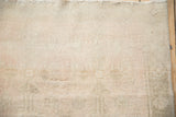 Distressed Oushak rug pile texture showing heavy abrashes, even wear, and antique ivory tones.