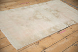 Textured distressed Oushak rug pile with heavy abrashes and faint foundation showing.