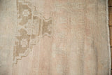 Vintage Distressed Oushak rug pile with heavy abrashes, subtle floral design, and muted tones.