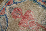 Heavy, distressed wear on the pictorial human figure motif of a vintage Turkish Sparta rug.