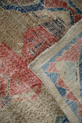 Corner of a distressed Sparta rug showing the worn-down pile and hand-knotted reverse.