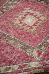 Detailed view of the hand-knotted texture and low pile on a distressed vintage Kurd rug runner.