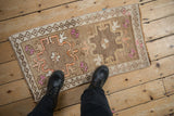 A personal, top-down view of a distressed Kars mat with its geometric medallion and floral accents.