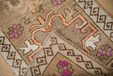 Folded corner of a vintage Kars rug revealing its hand-knotted construction and short pile.