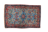Fine vintage Bibikabad rug with a floral medallion on a sky blue field and cochineal red border.