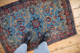 A standing view over the plush, sky blue field of a vintage hand-knotted Bibikabad rug.