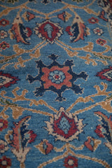 Fine, plush hand-knotted pile showing cochineal red and navy blue floral cross sections.
