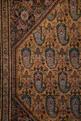 Fine weave of a vintage Persian Sarouk rug with a dark Herati corner over a saffron boteh field.
