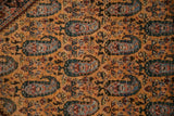Finely woven paisley boteh motifs in blue and terracotta on the dense saffron wool pile.