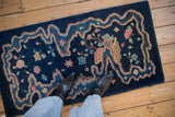 Cobalt blue Art Deco runner with asymmetric river-ribboned border and pastel floral motifs.