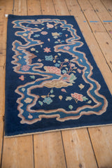 Art Deco vintage rug corner, cobalt blue field with ribboned border and pastel floral motifs.
