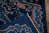 Art Deco rug folded, showing deep blue pile, river ribbon design, and woven back.