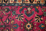 Vintage Lilihan rug's plush pile, showcasing magenta, indigo, and copper floral motifs.