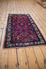 Plush magenta pile on a Lilihan rug corner with floral patterns and fringe.