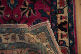 Plush magenta pile, floral motifs, and fine hand-knotted back of this vintage Lilihan rug.