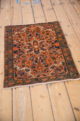 Vintage Hamadan rug mat corner, with thin border of meandering vines, burnt orange field, and fringe.