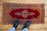 Upper right corner of Vintage Anatolian rug showing saffron yellow spandrel, red vine border, and tatter.