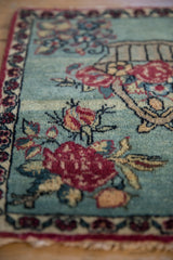 The soft, even pile of an antique Kerman rug with detailed cochineal red floral sprays.
