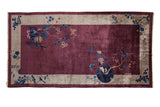 Antique Chinese Art Deco carpet with pictorial cherry blossoms in cobalt blue on a lustrous aubergine field with a silver border.