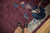 Lustrous aubergine wool pile with cobalt blue butterfly and silver-grey pictorial corner design.