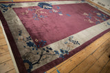Lustrous wool pile of an antique Art Deco carpet with cherry blossoms, viewed from a low angle.