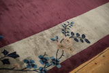 Lustrous silver and aubergine border of an antique Art Deco carpet with blue floral details.