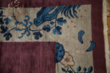 Reverse side of the antique Art Deco carpet's corner, showing the hand-knotted pile and faint historic markings.