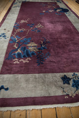 Corner detail of an antique Art Deco rug showing cloud band motifs and lustrous aubergine pile.