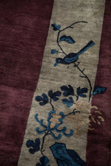 Expressive cobalt blue bird pictorial detail on the lustrous wool pile of an antique Chinese Art Deco carpet.