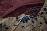 Lustrous, silk-like wool pile on an antique carpet in aubergine and silver with blue blossoms.