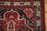Corner spandrel detail of a vintage Persian Bijar rug with a main border of floral bouquets.