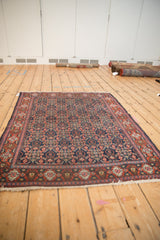 Vintage Senneh rug corner, intact side cord, navy Herati motif, red floral guls border.